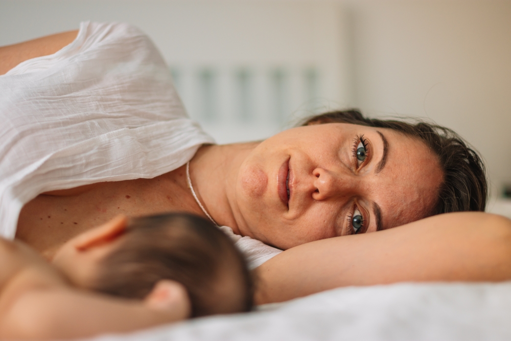 mom lying next to baby